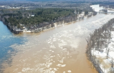 Aerial view of the sediment-filled water of the Little Fork River meeting the clear water of the Rainy River.